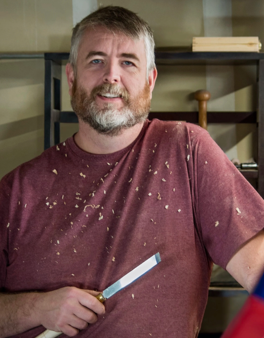 Brian Bretzinger in the woodshop holding a turning tool